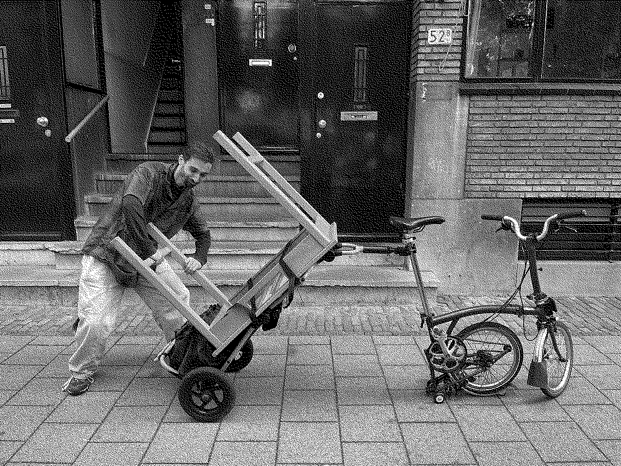 Elliott next to a bike trolley loaded with a small desk upside down behind a folding bicycle